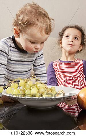 Girl and boy eating fruit View Large Photo Image Stock Photo - Girl and boy eating fruit. Fotosearch
