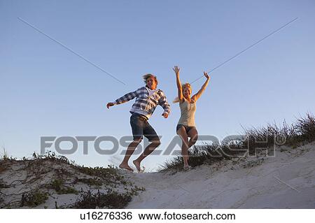 Stock Photograph - Girl and Boy jumping. Fotosearch