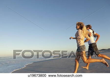 Stock Image - Girl and boy running. Fotosearch