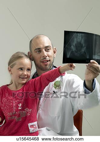 Stock Photo - Girl and doctor with x-ray. Fotosearch
