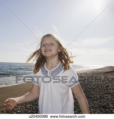 Girl at beach smiling at camera View Large Photo Image Stock Photograph - Girl at beach smiling at camera. Fotosearch