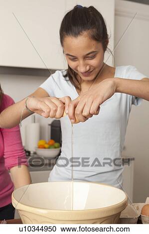 girl, breaking an egg in kitchen View Large Photo Image Stock Image - girl, breaking an egg in kitchen. Fotosearch
