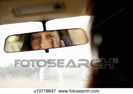 Stock Photo - Girl checking in mirror. Fotosearch