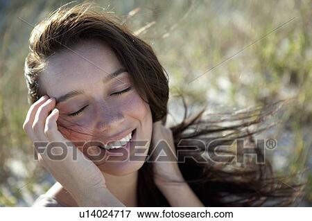 Stock Photo - Girl closing her eyes. Fotosearch