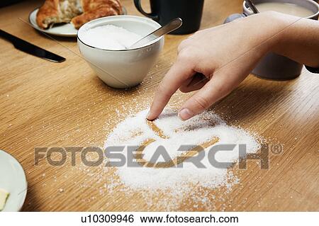 Girl drawing hart in sugar on table View Large Photo Image Stock Photograph - Girl drawing hart in sugar on table. Fotosearch