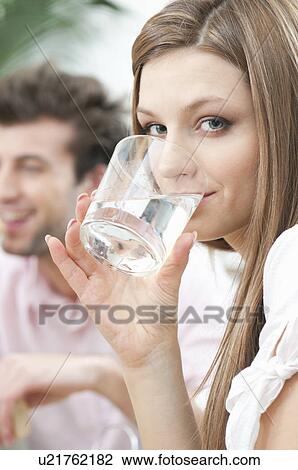 Girl drinking glass of water at home View Large Photo Image Stock Image - Girl drinking glass of water at home. Fotosearch