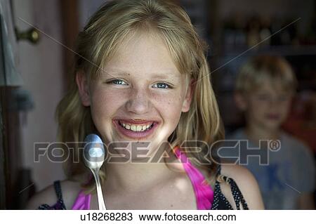 Stock Image - Girl eating chocolate. Fotosearch