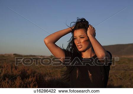 Stock Image - Girl facing the sun. Fotosearch