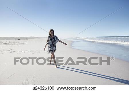 Stock Image - Girl going on beach. Fotosearch