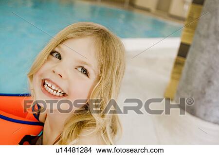 Picture - Girl in floaters by swimming pool. Fotosearch