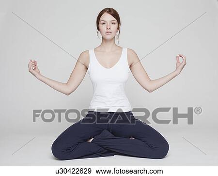 girl in lotus position on white background View Large Photo Image Stock Photo - girl in lotus position on white background. Fotosearch