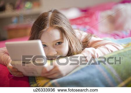 Stock Photograph - girl in lotus position on white background. Fotosearch