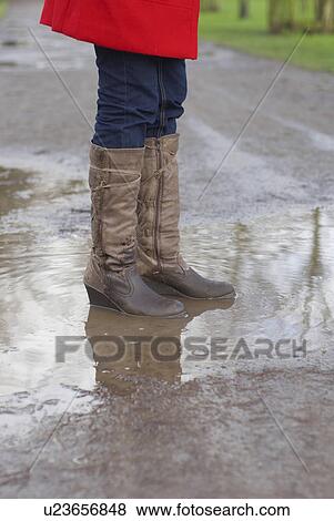 Stock Photo - Girl in red jacket with brolley in park. Fotosearch