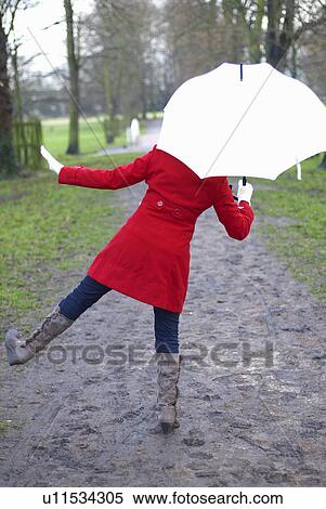 Girl in red jacket with brolley in park View Large Photo Image Stock Photography - Girl in red jacket with brolley in park. Fotosearch