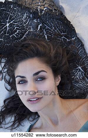Stock Image - Girl laying on wood. Fotosearch