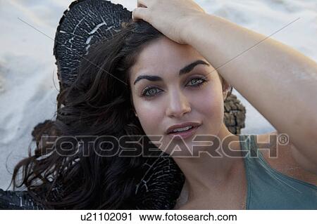Stock Image - Girl laying on wood. Fotosearch