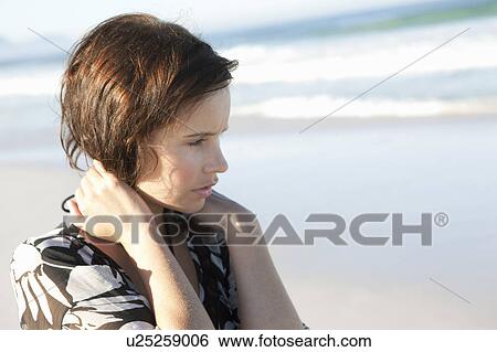 Stock Photograph - Girl looking at sea. Fotosearch