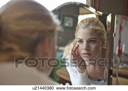 Stock Image - Girl looking in mirror. Fotosearch