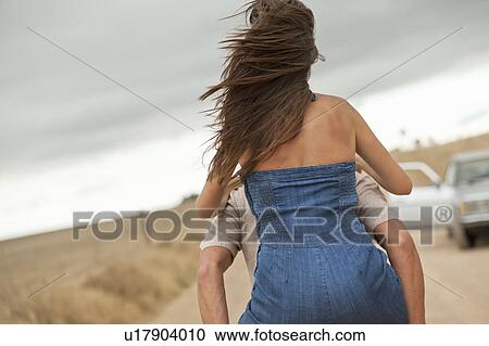Girl on boys back View Large Photo Image Stock Image - Girl on boys back. Fotosearch