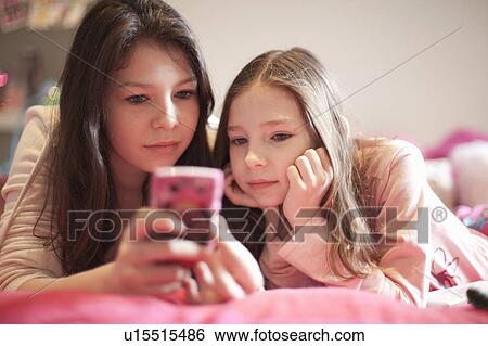 girl playing nintendo lying on bed View Large Photo Image Stock Photograph - girl playing nintendo lying on bed. Fotosearch