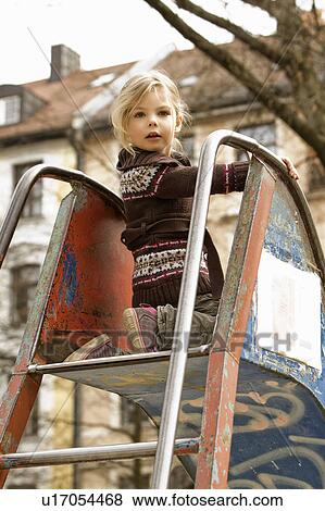 Girl playing on slide outdoors View Large Photo Image Stock Photo - Girl playing on slide outdoors. Fotosearch