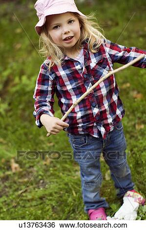 Girl playing with stick outdoors View Large Photo Image Stock Photograph - Girl playing with stick outdoors. Fotosearch