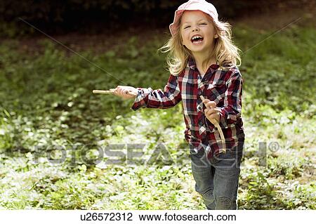 Girl playing with sticks outdoors View Large Photo Image Stock Image - Girl playing with sticks outdoors. Fotosearch