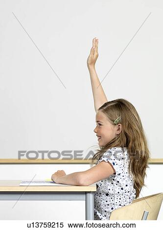 Girl raising hand in classroom View Large Photo Image Stock Photography - Girl raising hand in classroom. Fotosearch
