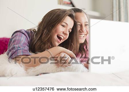 Stock Photograph - girl reading a book in pajamas. Fotosearch