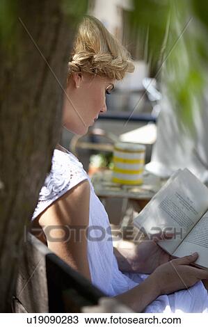 Stock Image - Girl reading. Fotosearch