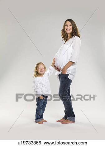 Girl rubbing pregnant mother’s belly View Large Photo Image Stock Photograph - Girl rubbing pregnant mother’s belly. Fotosearch
