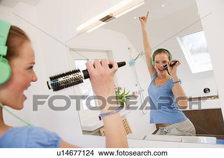 Girl singing in bathroom View Large Photo Image Picture - Girl singing in bathroom. Fotosearch