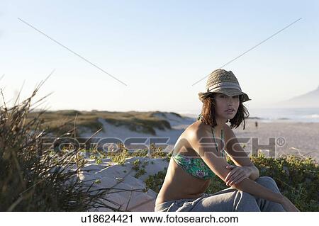 Girl sitting in dunes View Large Photo Image Stock Image - Girl sitting in dunes. Fotosearch