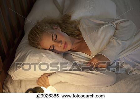 Stock Photography - Girl sleeping in bed. Fotosearch