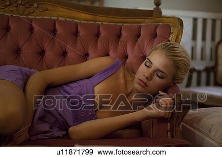 Stock Photo - Girl sleeping on couch. Fotosearch