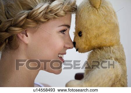 Girl smiling at teddy View Large Photo Image Stock Image - Girl smiling at teddy. Fotosearch