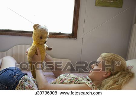 Girl speaking with teddy View Large Photo Image Stock Photo - Girl speaking with teddy. Fotosearch