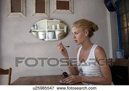 Girl tasting cake View Large Photo Image Stock Photo - Girl tasting cake. Fotosearch