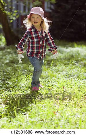 Girl walking in backyard View Large Photo Image Stock Photo - Girl walking in backyard. Fotosearch