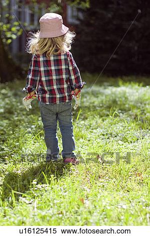Stock Photography - Girl walking in backyard. Fotosearch