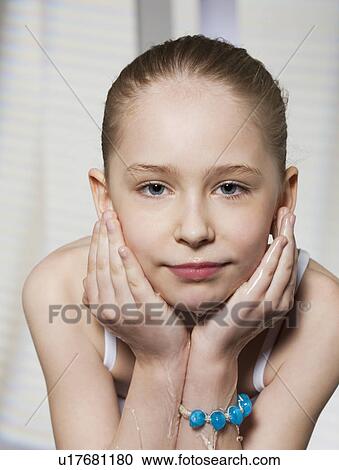 Stock Image - Girl washing her face. Fotosearch