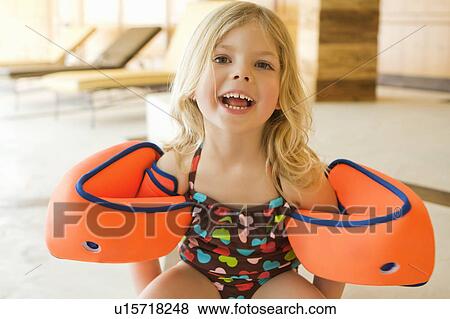 Stock Photo - Girl wearing bathing suit and floaters. Fotosearch