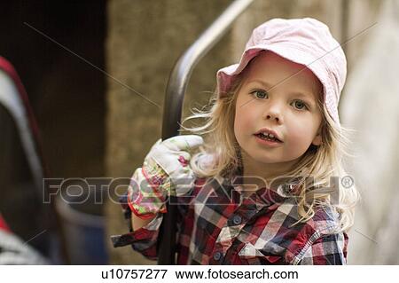 Girl wearing gardening gloves View Large Photo Image Stock Photo - Girl wearing gardening gloves. Fotosearch