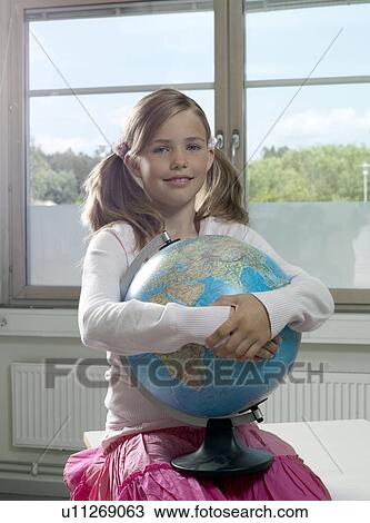 Stock Image - Girl with earth globe. Fotosearch