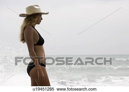 Girl with sraw hat. ocean behind her View Large Photo Image Stock Photography - Girl with sraw hat. ocean behind her. Fotosearch