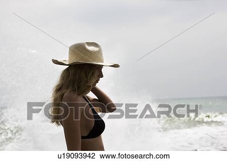 Girl with straw hat, water splashing behind her View Large Photo Image Stock Image - Girl with straw hat, water splashing behind her. Fotosearch