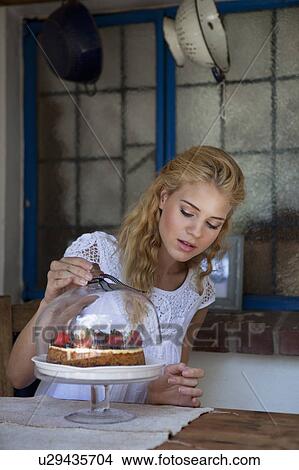 Picture - Girl with strawberry cake. Fotosearch