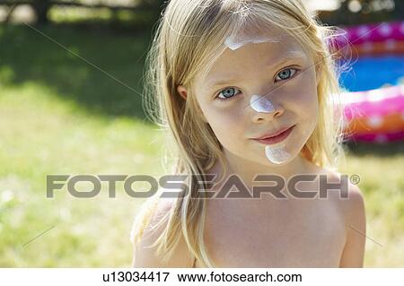 Girl with sunscreen cream on her face View Large Photo Image Stock Photo - Girl with sunscreen cream on her face. Fotosearch