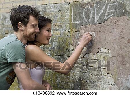 Girlfriend writing LOVE on a wall View Large Photo Image Stock Image - Girlfriend writing LOVE on a wall. Fotosearch