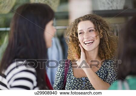 Stock Image - Girlfriends having shopping fun. Fotosearch